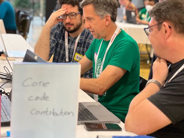 Mike Anello (mentor) and two team members working on a core issue at Drupalcon Lille 2023.